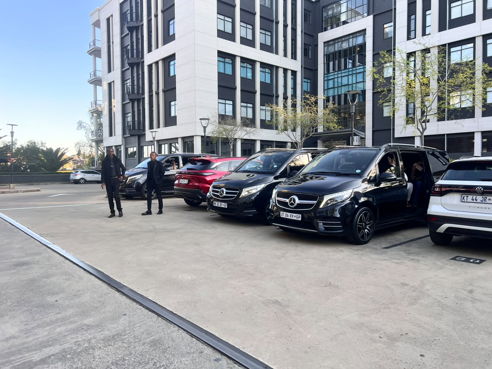 A2B Shuttle chauffeurs and Mercedes V-Class fleet outside Engen head office, Sandton